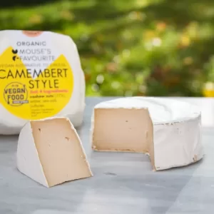 Camembert vegan cheese by Mouse's Favourite with packaging in background and an unwrapped wheel in front of it