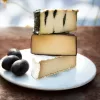 Special occasion vegan cheese by Mouse's Favourite - tower of 3 cheese types cut in half in regular size wheels.