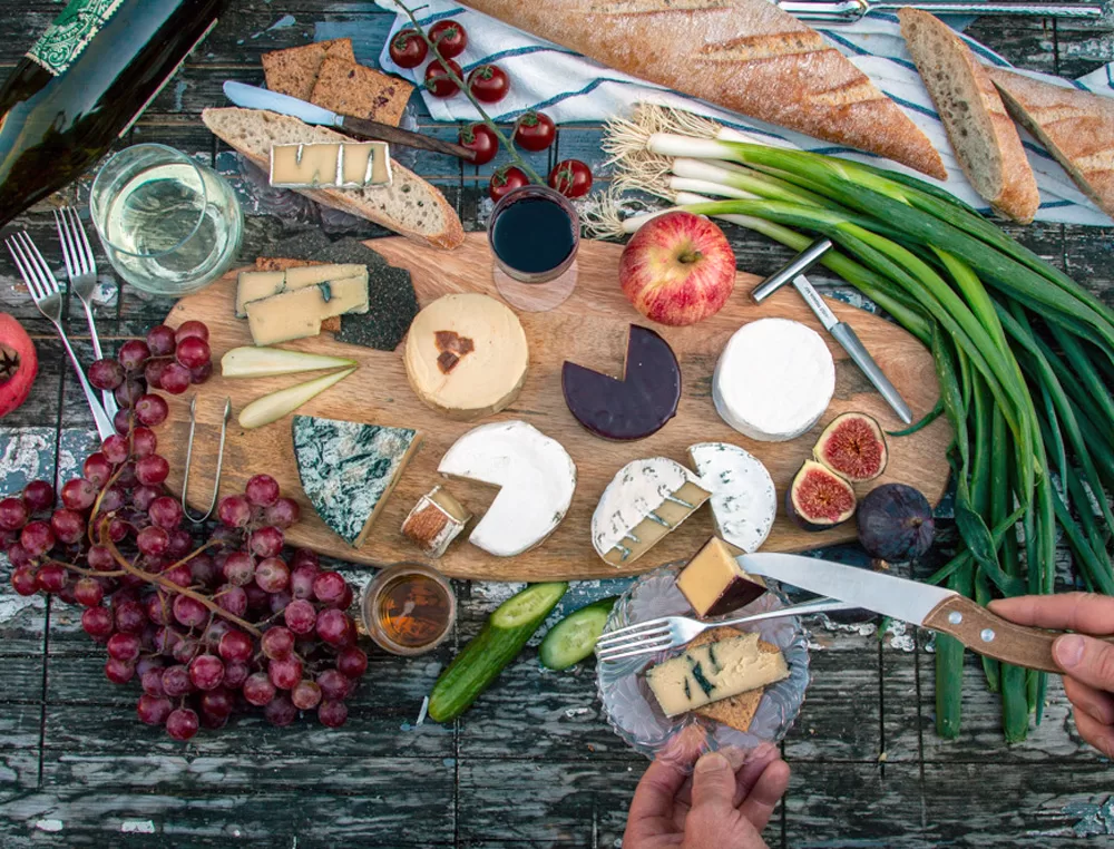 Special occasion vegan cheese by mouse's favourite casual picnic cheeseboard selection on painted table