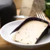 Special occasion vegan cheese by Mouse's Favourite - cut slice from large wheel of aged classic.